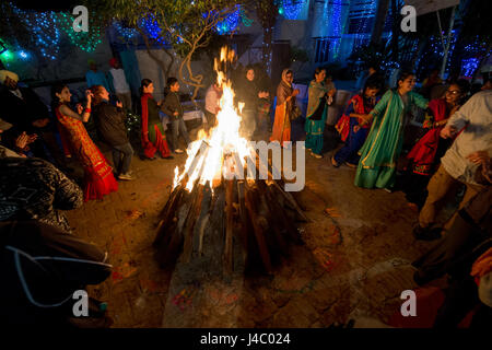 People dancing around the bonfire at the Lohri celebration in Punjab, India. Stock Photo