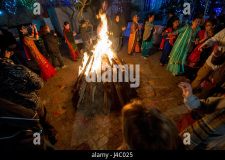 People dancing around the bonfire at the Lohri celebration in Punjab, India. Stock Photo