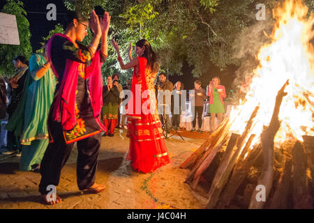 People dancing around the bonfire at the Lohri celebration in Punjab, India. Stock Photo