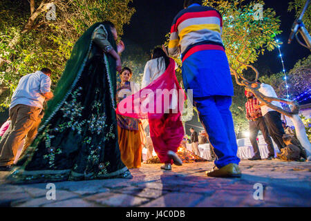 People dancing around the bonfire at the Lohri celebration in Punjab, India. Stock Photo