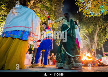 People dancing around the bonfire at the Lohri celebration in Punjab, India. Stock Photo