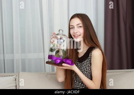 happy girl with big bouquet of pink roses, received as a gift Stock Photo