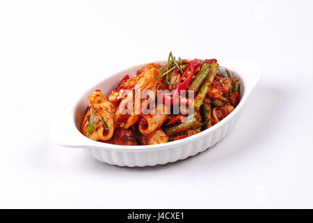 Thai recipe , Spicy fried cowpea and squid with roasted chile paste, isolated on white background. Stock Photo