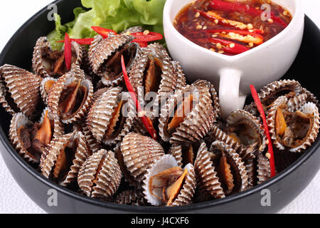 Fresh and delicious soft-boiled blood cockles shell  served with spicy sauce  in Korea pattern black dish Stock Photo