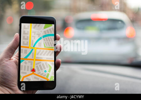 GPS Navigation on Mobile Phone Device and Transportation Concept. Male Hand Using Navigation System Map Tracking on Smartphone with Copy Space. Stock Photo