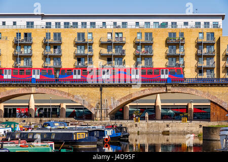 Waterside apartments at Limehouse Basin Marina in London with Docklands Light Railway passing by Stock Photo