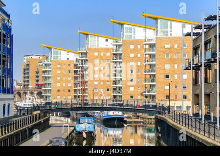 Waterside apartments at Limehouse Basin Marina  with Docklands Light Railway passing in the background Stock Photo