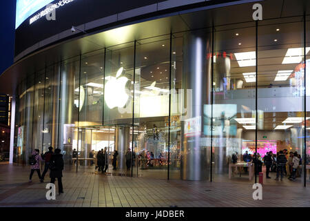 People walking in front of Apple store on Wangfujing street in Beijing, China. This store is Asia's biggest Apple store Stock Photo