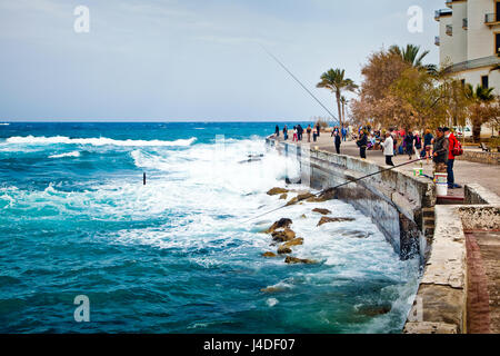 Embankment with fishermen in old town Kyrenia, Northern Cyprus Stock Photo