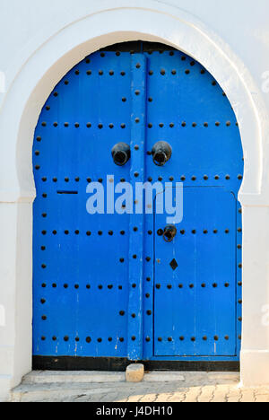 Arched Doorway with Blue Studded Door, Africa, North Africa, Tunisia, Sidi Bou Said Stock Photo
