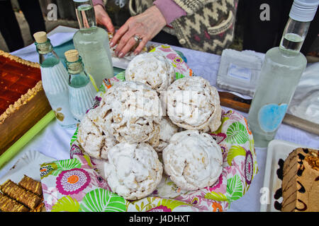 Small cakes and drinks exposed on the table for tasting and sale. Stock Photo