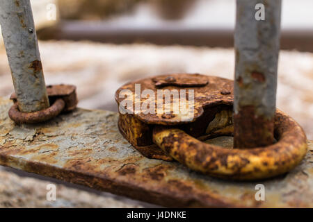 Close-up of two rusty vintage padlocks on the pedestrian bridge fence. Stock Photo