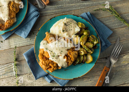 Homemade Country Fried Steak with Gravy and Potatoes Stock Photo