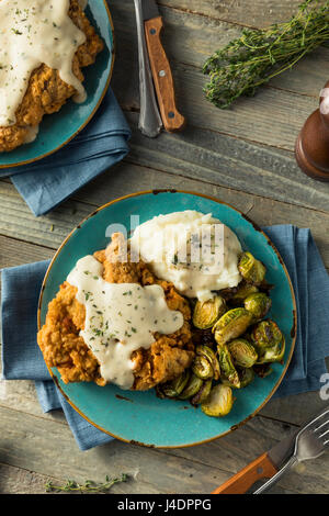 Homemade Country Fried Steak with Gravy and Potatoes Stock Photo