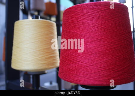 Reels or spools of multicolored sewing threads. Threads of all colors. Stock Photo