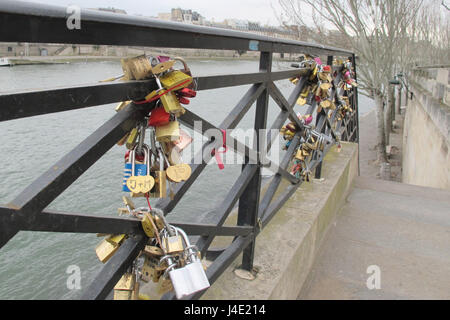 Paris, France. 22nd Feb, 2017. Love locks are attached at a railing at Pont des Arts' pedestrian bridge at the Seine in Paris, France, 22.02.2017. When the city of Paris removed the attached locks due to safety reasons in 2015, a couple saved several hundred. Now these locks are looking for their owners. Photo: Nadine Benedix/dpa/Alamy Live News Stock Photo