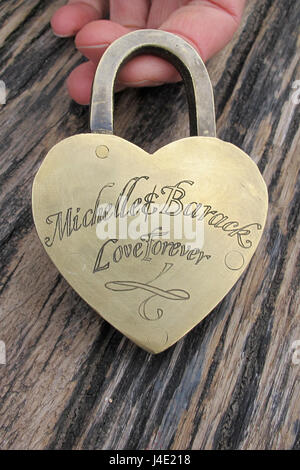 Paris, France. 22nd Feb, 2017. A man holds a love lock with the inscription 'Michelle & Barack Love Forever' in his hands at Pont des Arts' pedestrian bridge at the Seine in Paris, France, 22.02.2017. When the city of Paris removed the attached locks due to safety reasons in 2015, a couple saved several hundred. Now these locks are looking for their owners. Photo: Nadine Benedix/dpa/Alamy Live News Stock Photo