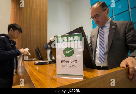 (170512) -- TORONTO, May 12, 2017 (Xinhua) -- A WeChat Pay logo is seen on a cashier desk of a shop at Yorkdale Shopping Centre in Toronto, Canada, May 11, 2017. Canada's shopping mall Yorkdale Shopping Centre started accepting China's WeChat Pay from May 2017. Tourism Toronto and OTT Financial Group have introduced the Chinese mobile payment service, WeChat Pay, into local tourism to boost travel and shopping consumption by Chinese travelers.(Xinhua/Zou Zheng)(gj) Stock Photo