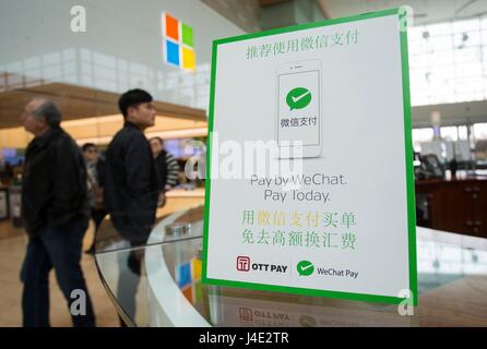(170512) -- TORONTO, May 12, 2017 (Xinhua) -- A WeChat Pay logo is seen on a desk of service centre at Yorkdale Shopping Centre in Toronto, Canada, May 11, 2017. Canada's shopping mall Yorkdale Shopping Centre started accepting China's WeChat Pay from May 2017. Tourism Toronto and OTT Financial Group have introduced the Chinese mobile payment service, WeChat Pay, into local tourism to boost travel and shopping consumption by Chinese travelers.(Xinhua/Zou Zheng)(gj) Stock Photo