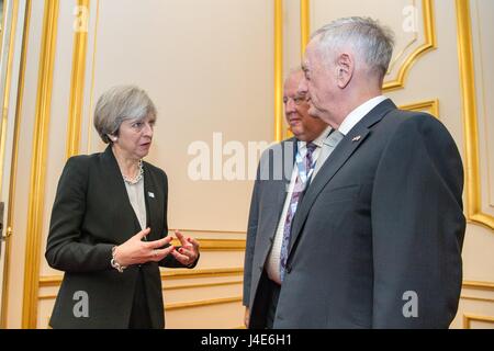 U.S. Secretary of Defense James Mattis, right, listens to British Prime Minister Theresa May on the sidelines of the London Somalia Conference at the Lancaster House May 11, 2017 in London, United Kingdom.  U.S. Under Secretary Of State For Political Affairs Thomas Shannon is standing next to Mattis. Stock Photo