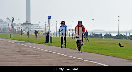 Brighton, UK. 13th May, 2017. Cyclists and roller bladers travel along Brighton and Hove seafront on a dull overcast morning . The forecast is for a mixture of sunshine and showers this weekend in the south with warnings of a water shortage due to a lack of rain this Spring Credit: Simon Dack/Alamy Live News Stock Photo