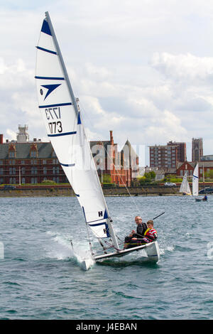 Catamaran Yachting on a windy Southport, Merseyside.  UK Weather.  Clearing Skies and a Fresh breeze over Marine Lake as Southport Sailing Club stages it 2017 Open Day. The club is fully booked for trial and novice sailors to enjoy one half hour on the resorts Marine Lake, in testing conditions, on a variety of craft. As has been the case for the last few years this coincides with the RYA push the boat out initiative – to nationally get people on the water and interested in sailing! Credit; MediaWorldImage/AlamyLiveNews Stock Photo