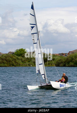 Catamaran Yachting on a windy Southport, Merseyside.  UK Weather.  Clearing Skies and a Fresh breeze over Marine Lake as Southport Sailing Club stages it 2017 Open Day. The club is fully booked for trial and novice sailors to enjoy one half hour on the resorts Marine Lake, in testing conditions, on a variety of craft. As has been the case for the last few years this coincides with the RYA push the boat out initiative – to nationally get people on the water and interested in sailing! Credit; MediaWorldImage/AlamyLiveNews Stock Photo