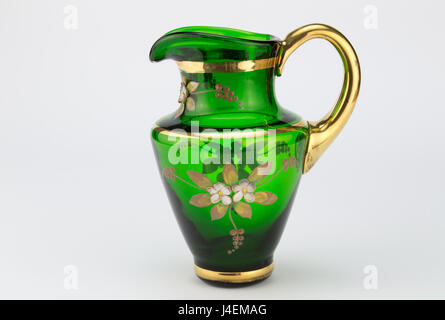 Vintage green and gold glass hand blown milk jug isolated on white background - from Venice Stock Photo