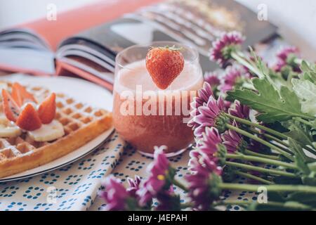 Breakfast variations. Waffles with strawberry smoothie. Stock Photo