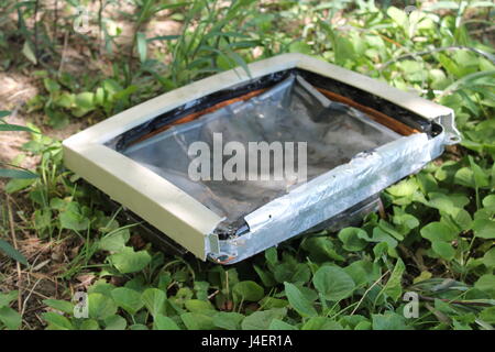 Composition of a broken computer on the grass. Stock Photo