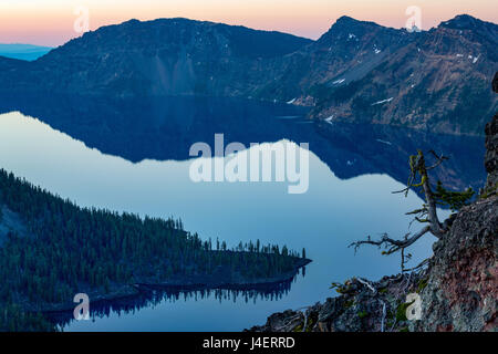 Wizard Island and the still waters of Crater Lake at dawn, the deepest lake in the USA, part of the Cascade Range, Oregon, USA Stock Photo