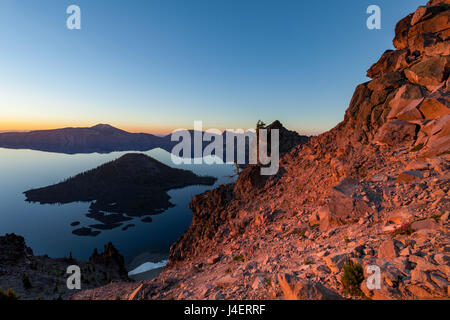 Wizard Island and the still waters of Crater Lake at dawn, the deepest lake in the USA, part of the Cascade Range, Oregon, USA Stock Photo