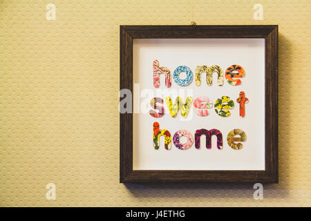 Framed letters home sweet home hung on a wall