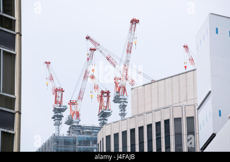 Construction cranes in downtown Tokyo Stock Photo