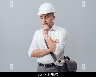 Construction engineer thinking with hand on chin, problem solving and solutions concept Stock Photo