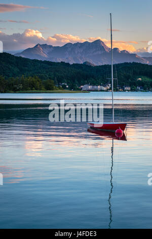 Sailing yacht on the Woerthersee with the Alps in the background Stock Photo