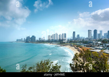 Tel Aviv skyline by day with beach, sea and waves Stock Photo