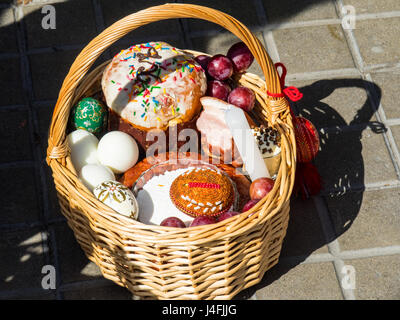 A cane basket filled with Easter offerings of eggs and cakes to celebrate the Russian Orthodox Easter. Stock Photo