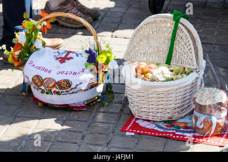 Cane baskets covered with embroidered napkins with Easter offerings of eggs and cakes to celebrate the Russian Orthodox Easter. Stock Photo