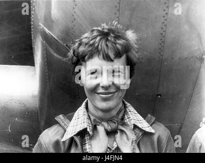 Amelia Earhart standing under nose of her Lockheed Model 10-E Electra. Stock Photo