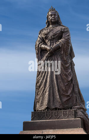 Auckland, New Zealand - March 5, 2017: Closeup of Black metal statue of Queen Victoria in Albert Park under blue sky. Stock Photo