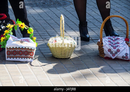 Cane baskets covered with embroidered napkins with Easter offerings of eggs and cakes to celebrate the Russian Orthodox Easter. Stock Photo