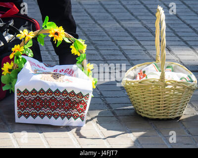 Cane baskets covered with embroidered napkins with Easter offerings of eggs and cakes to celebrate the Russian Orthodox Easter. Stock Photo