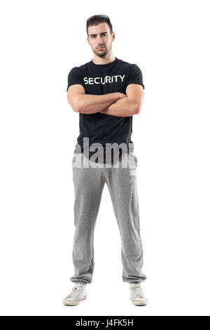 Tough macho bouncer wearing waist bag with crossed arms looking at camera. Full body length portrait isolated on white studio background. Stock Photo