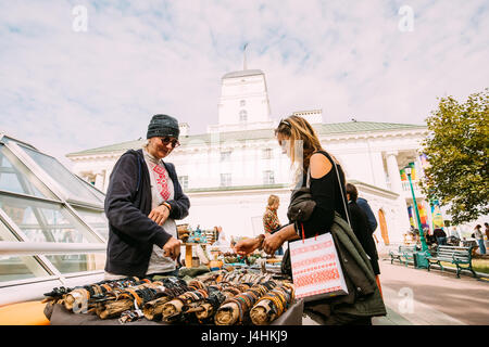 Minsk, Belarus - September 3, 2016: Woman Buying Souvenirs  On Street Market In Freedom Square Near Town Hall. Trading trays With Sale Of Gifts, Sweet Stock Photo