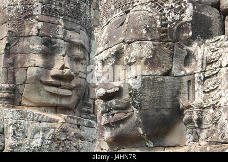 Carved stone faces on Angkor Thom temple Stock Photo