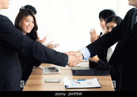 Asian businessman shaking hands in conference room. Business people shaking hands agreement concept. Stock Photo