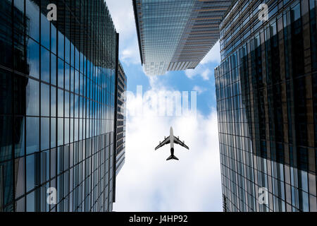 Tokyo skyscrapers buildings and a plane flying overhead at in Tokyo Shinjuku downtown and business district in morning at Tokyo, Japan. Stock Photo