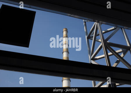 Stack of Heart Electropower Station. The stack and the metal structure of the front of the blue sky. Stock Photo