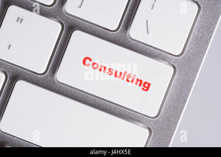 "Consulting" red words on white keyboard - online, education and business concept Stock Photo